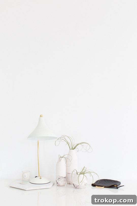 A close-up shot of a DIY marble dipped vase with fresh flowers, perfect for home styling.