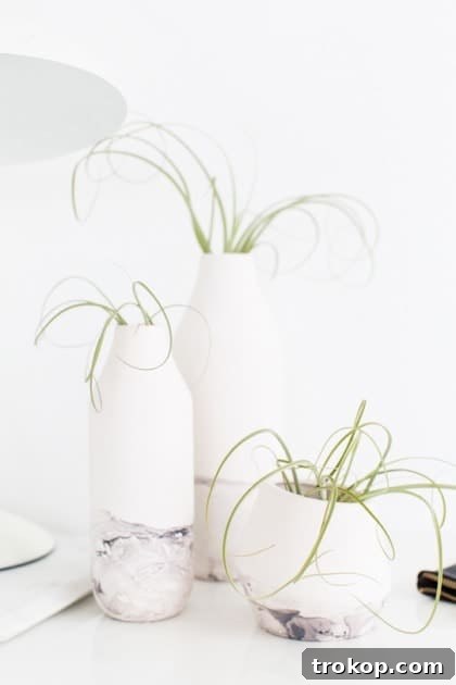 Finished DIY marble dipped vase with fresh flowers, ready for home decor.