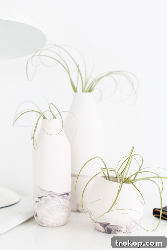 Close-up of a DIY marble dipped vessel, highlighting the intricate grey and black patterns.