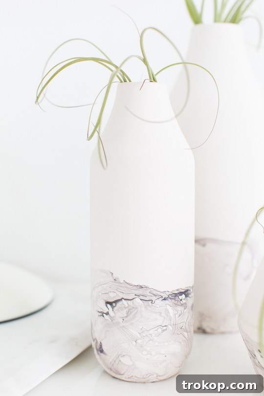 A finished DIY marble dipped vase sitting elegantly as a home decor item.
