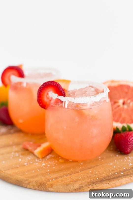 Strawberry Grapefruit Salty Dog Cocktail - a refreshing blend of tart grapefruit, sweet strawberry, and premium vodka with a salty rim.