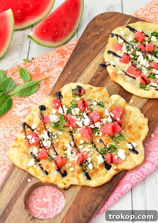 Watermelon Feta Flatbread perfectly sliced and ready to serve on a rustic board - Sugar & Cloth