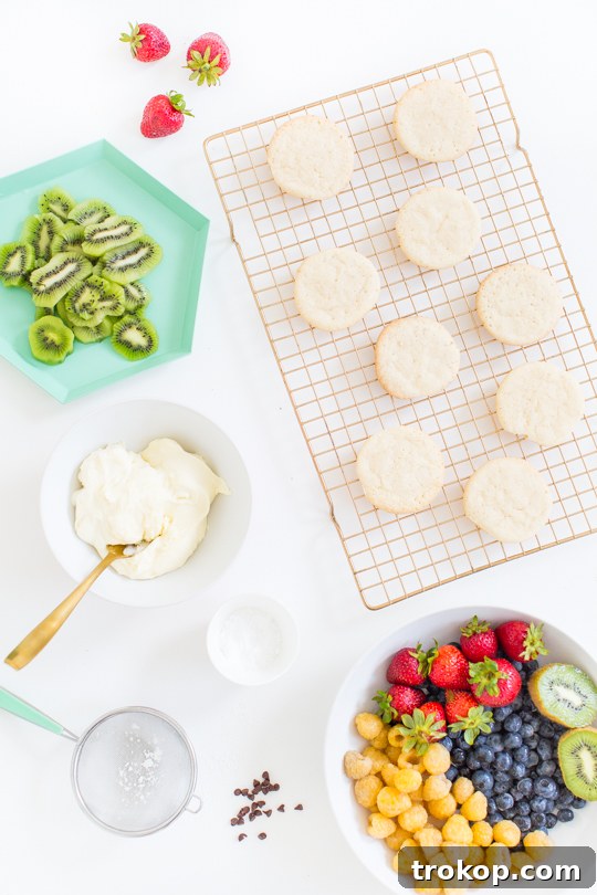Colorful assortment of Fruit Pizza Cookies on a white serving platter, ready for a party