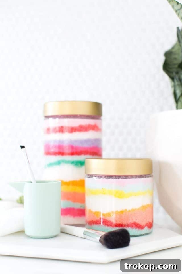 Rainbow Layered Sugar Scrub Craft 2 A beautifully layered Sand Art DIY Sugar Scrub in a clear jar, showcasing vibrant colors and smooth texture, ready to enhance any bathroom aesthetic.
