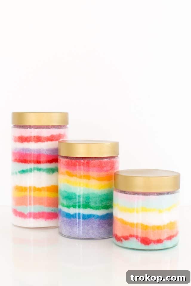 Rainbow Layered Sugar Scrub Craft 3 Several jars of DIY Sand Art Sugar Scrubs displaying a variety of vibrant colors and intricate patterns, perfect for customization and gifting.