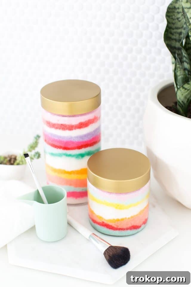 Rainbow Layered Sugar Scrub Craft 5 A person's hands mixing gel food coloring into a bowl of DIY sugar scrub base, demonstrating the process of coloring for the sand art effect.