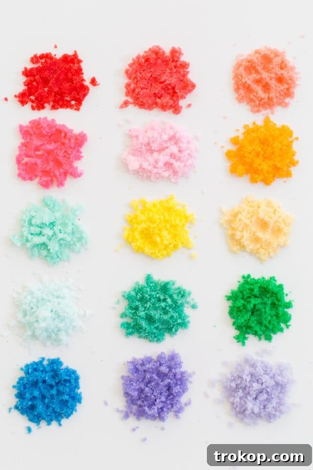Rainbow Layered Sugar Scrub Craft 9 Multiple clear glass jars filled with different vibrant sand art sugar scrubs, artfully arranged on a bathroom counter, highlighting customization and aesthetic appeal.