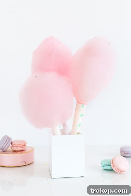 Preparing spiked cotton candy sugar on a sheet pan