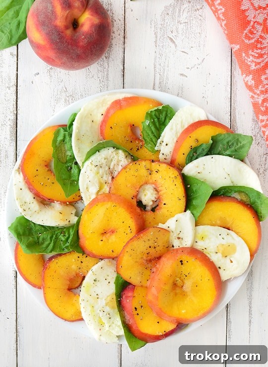 Caprese's Peachy Summer Twist 5 A vibrant platter of Peach Caprese Salad drizzled with balsamic glaze