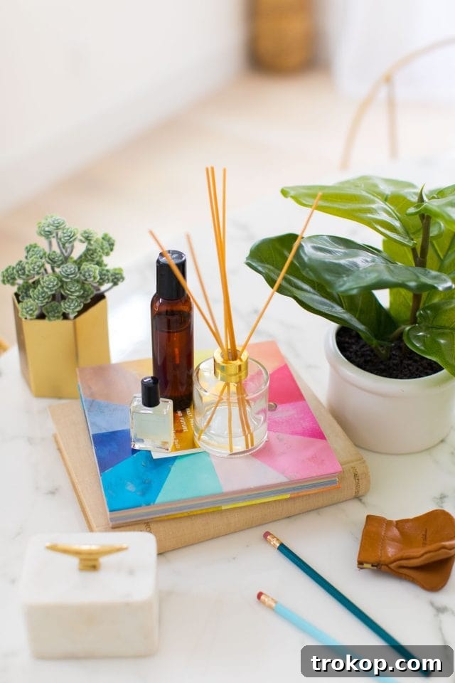 Handcrafted Home Fragrance 3 An elegant DIY essential oil diffuser with rattan reeds standing on a stack of books, creating a cozy and natural decor element.