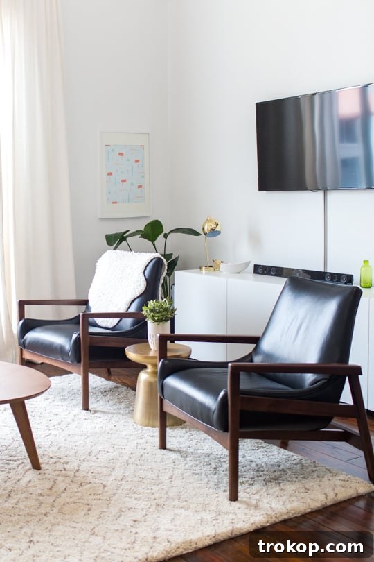 Apartment Living Room Reimagined 14 Arhaus sofa and accent chairs in a tastefully decorated living room, ready for comfortable lounging
