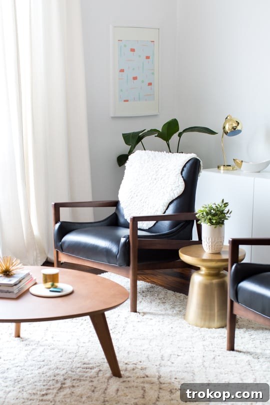 Apartment Living Room Reimagined 6 Bright and airy living room with a large window, personalized DIY artwork, and stylish Arhaus pieces