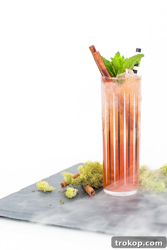 A classic Zombie cocktail, freshly shaken and served over ice, garnished with mint and cinnamon.