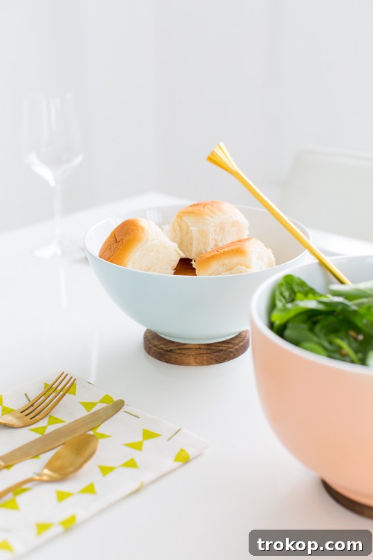 Three elegant DIY Footed Serving Bowls filled with various foods, including fruit, bread, and a side dish, ready for serving.