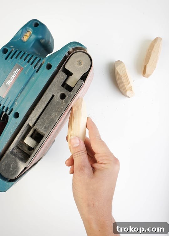 Sanding the wooden handles to smooth edges