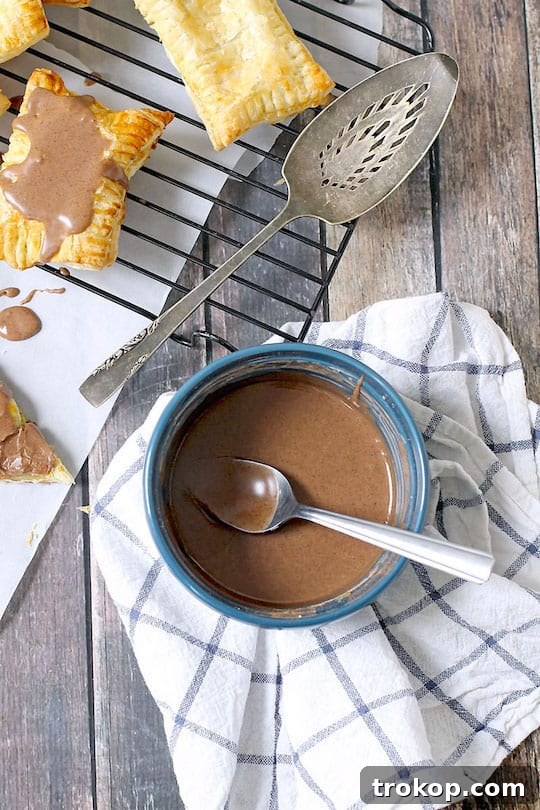 DIY Pumpkin Spice Toaster Pastries 4 Maple Cinnamon Frosting drizzled over a pop tart.