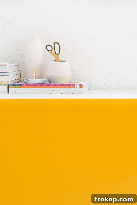 A creative space featuring the finished DIY color block Besta storage cabinets, showcasing organized drawers and vibrant decor.