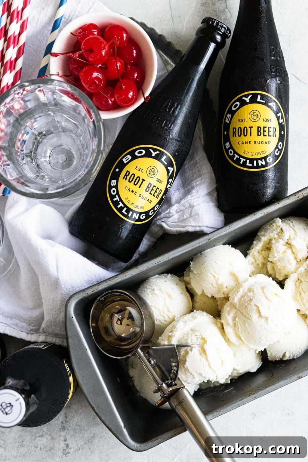 An easy ice cream serving trick shown: scoops of ice cream pre-arranged on a plastic-wrapped baking sheet for convenience.