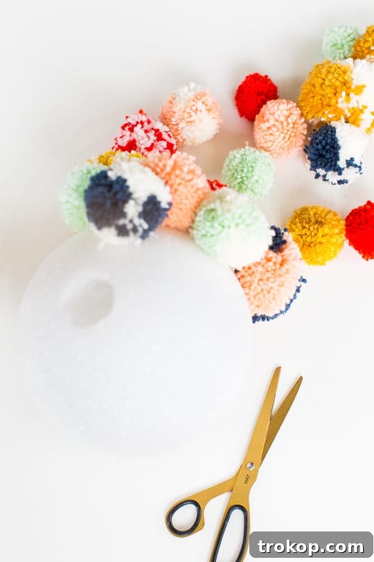 Martha Stewart's Holiday Crafting: Signature Tree Toppers & DIY Ornaments 15 Drilling a hole into a styrofoam sphere for the tree topper