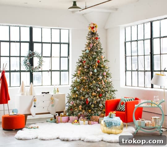 Martha Stewart's Holiday Crafting: Signature Tree Toppers & DIY Ornaments 7 Colorful Christmas ornaments and string lights on a snowy artificial tree