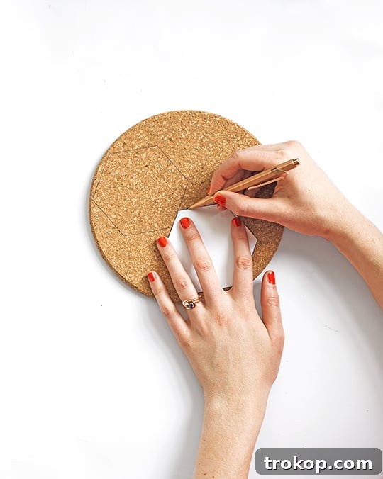 Tracing hexagon template onto cork sheets