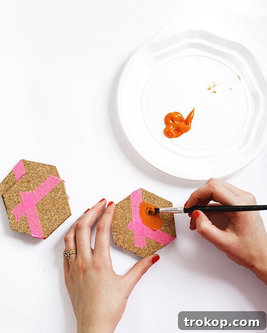 Masking off a section of the cork hexagon with washi tape