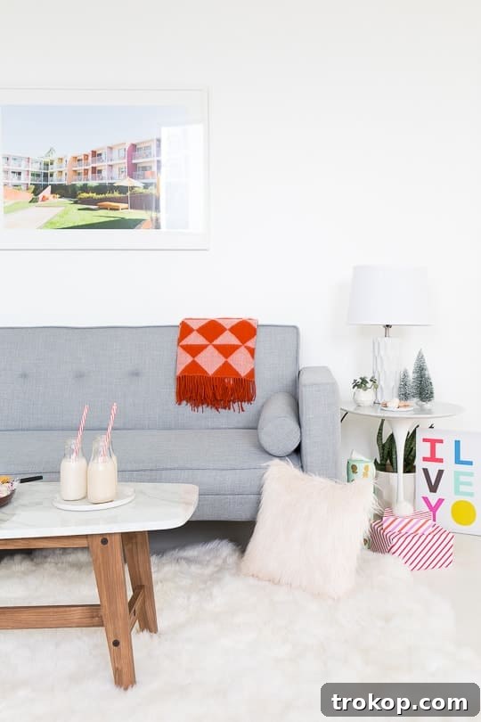A stylish faux marble coffee table in a modern studio setting, paired with a cozy sofa and festive decor.