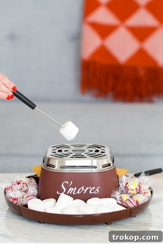 A charming tabletop s'mores maker, ready for festive holiday marshmallow roasting, surrounded by friends.