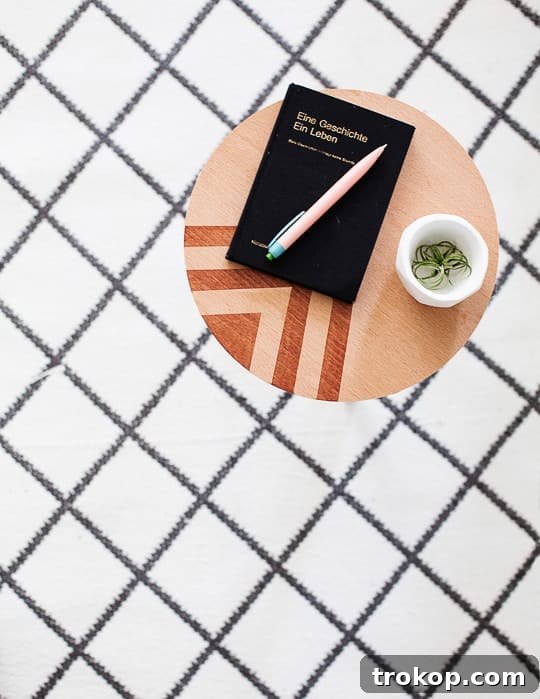 Close-up of DIY side table showing patterned top and white legs