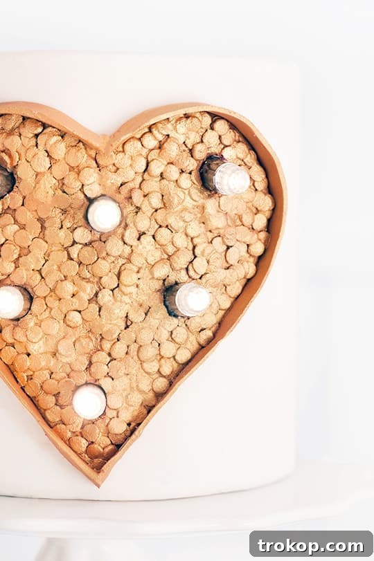 Close-up of LED lights carefully inserted into the marquee heart cake