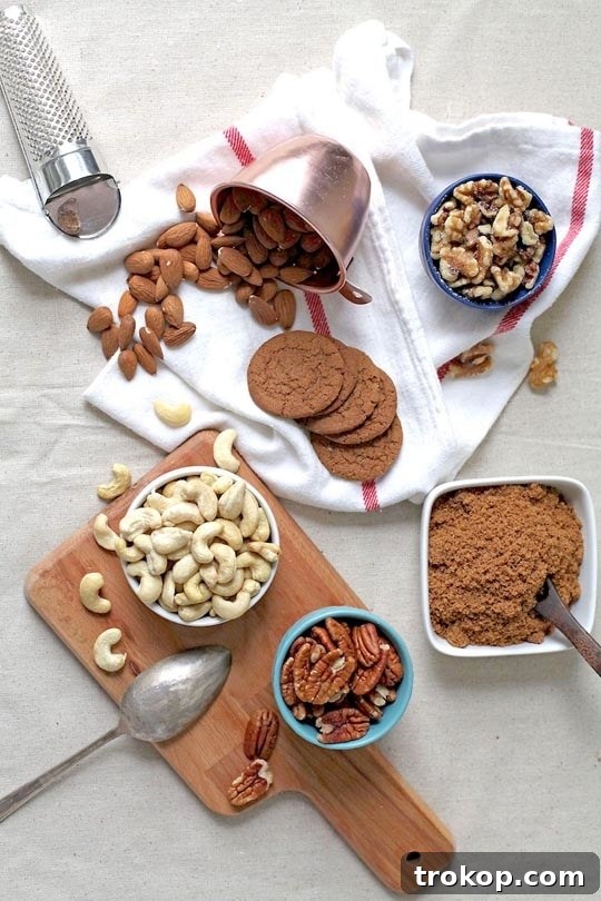 Gingerbread Candied Nuts spread on a baking sheet, cooling.