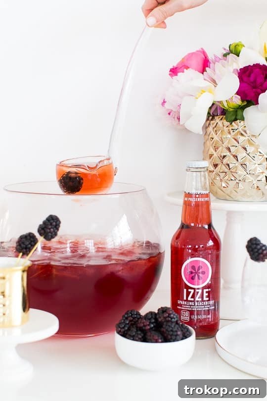 3-Ingredient Blackberry Champagne Fizz 7 Blackberry Champagne Punch being stirred in a punch bowl