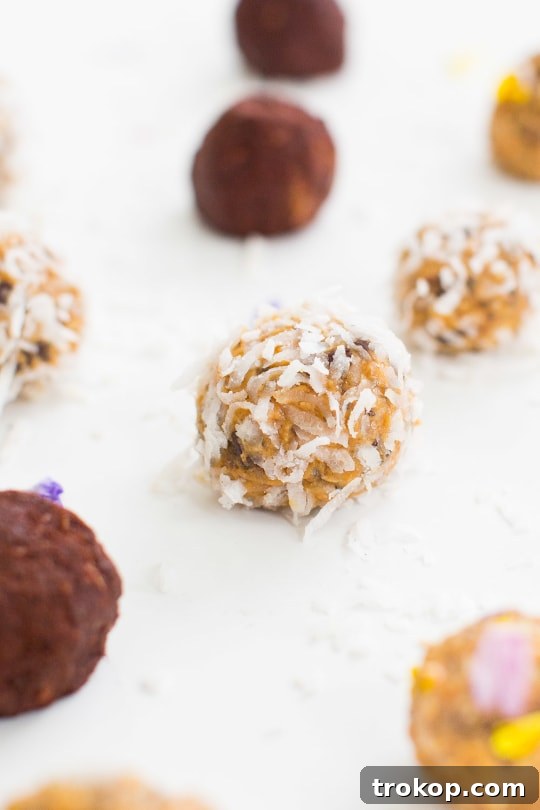 Hand rolling the peanut butter mixture into bite-sized energy balls on wax paper