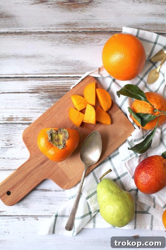 Ingredients laid out for a healthy and colorful winter fruit salad