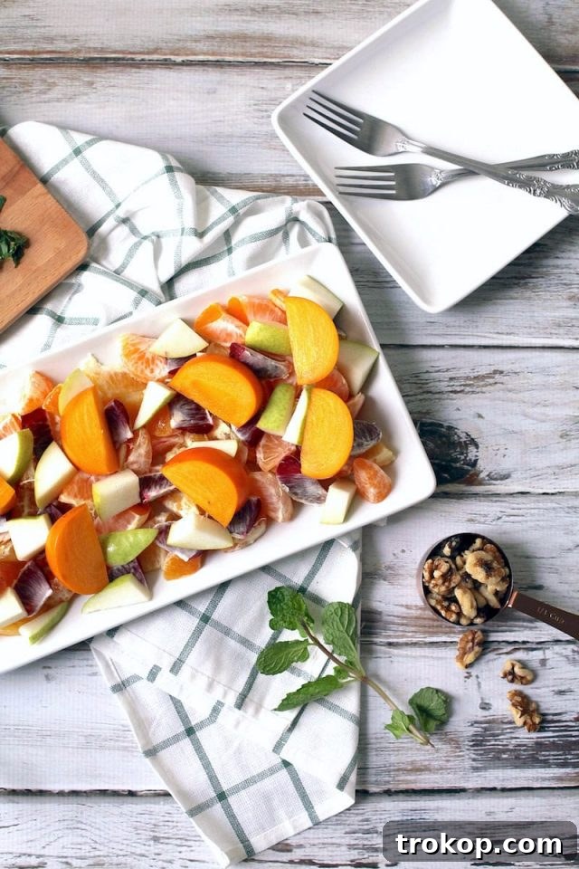 Winter fruit and citrus salad drizzled with homemade dressing, ready to serve