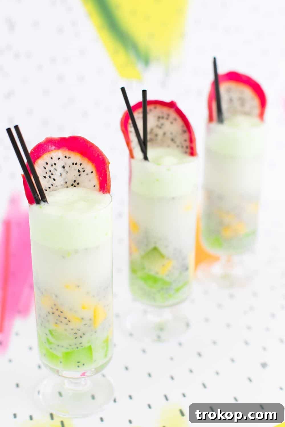 Patter Play: A captivating Dotted Thai Fruit Cocktail, garnished with exotic dragonfruit, showcasing its unique basil seed pattern and layers of flavor against a complementary background.