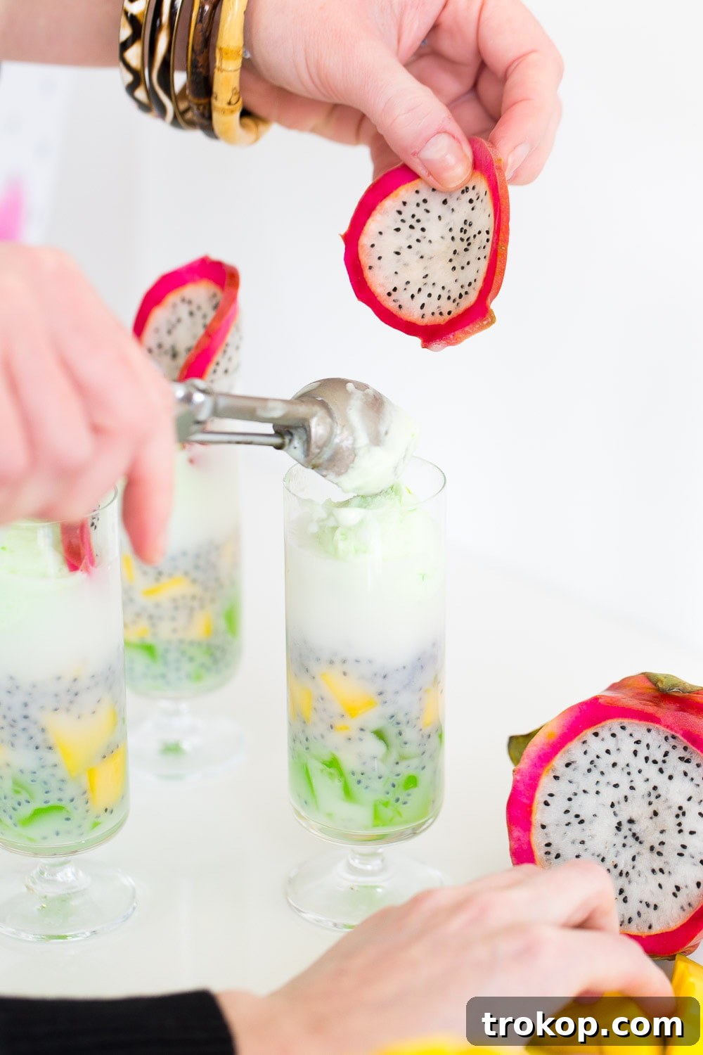 Tropical Thai Fruit Cocktail Recipe 6 Patter Play: A close-up shot revealing the texture and layered ingredients of the Dotted Thai Fruit Cocktail, served in a stylish glass with a vibrant backdrop.