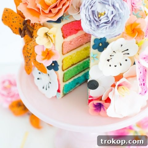 A beautifully decorated DIY sugar flower cake with spring motifs.