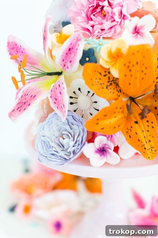 A charming sugar flower cake adorned with delicate edible blooms, serving as a beautiful topper.