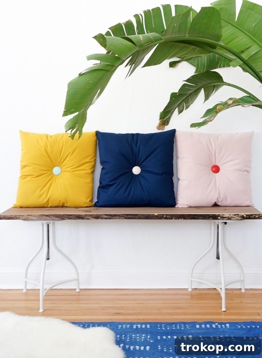 Colorful DIY tufted pillows in a mid-century modern setting