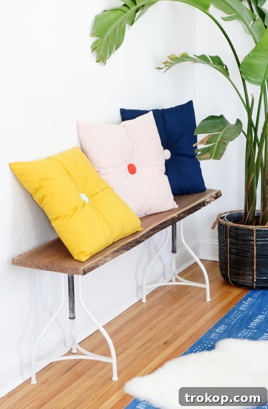 Close-up of a colorful DIY tufted pillow showcasing the tufted button detail