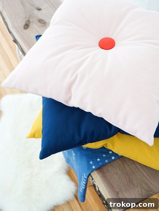 DIY tufted pillow being crafted, showing fabric and tools