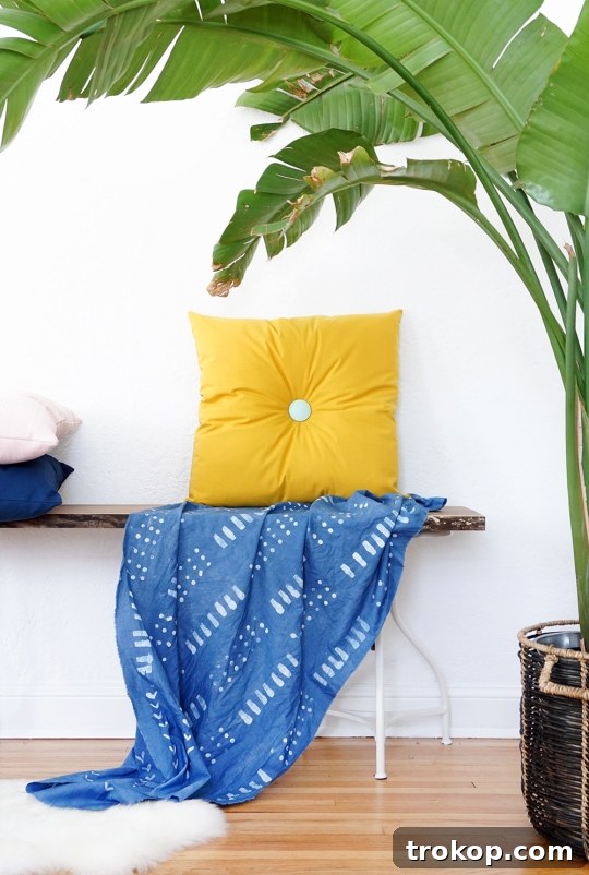 Group of colorful DIY tufted pillows on a sofa