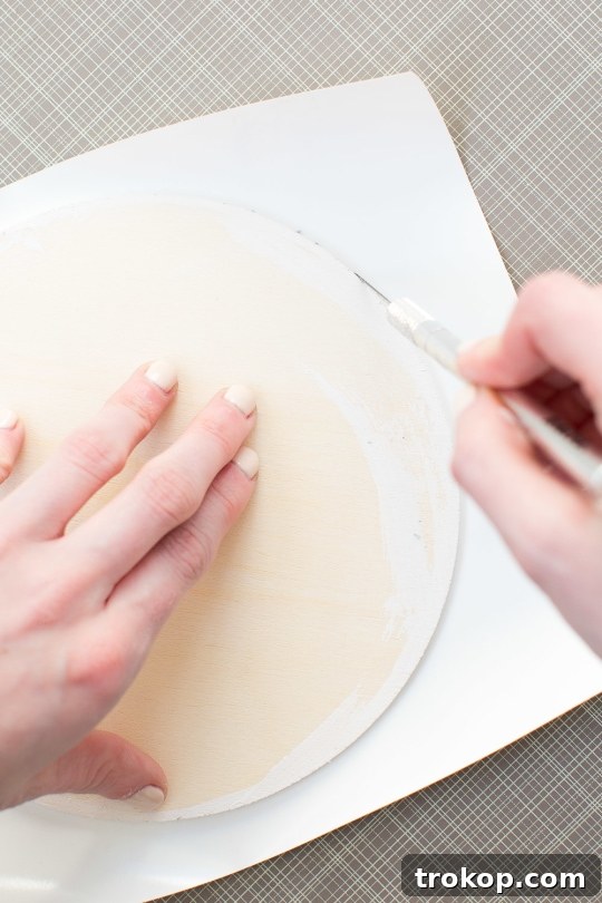 DIY Chic Marbled Plates 6 Applying marble contact paper to a wooden circle