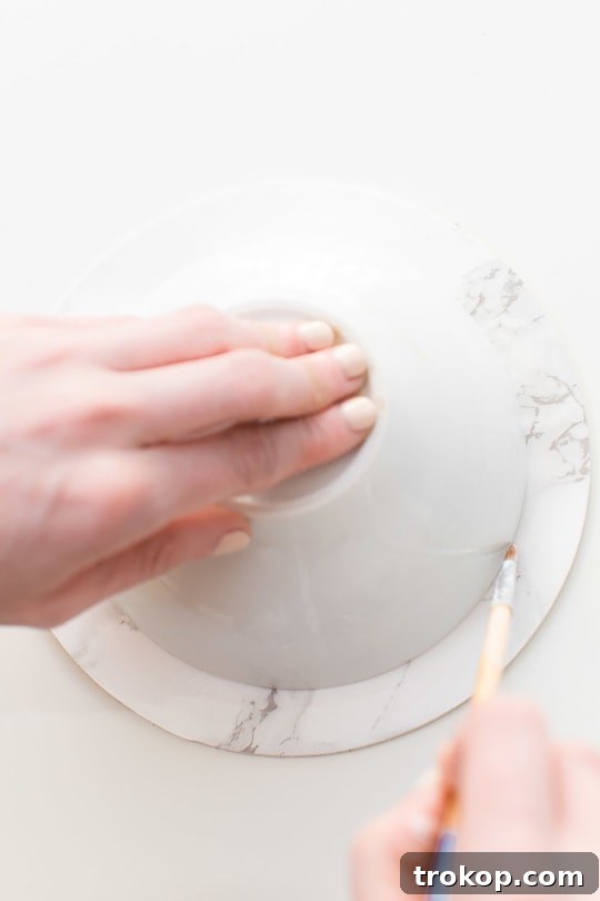 DIY Chic Marbled Plates 7 Applying foil adhesive to the rim of a DIY marble plate