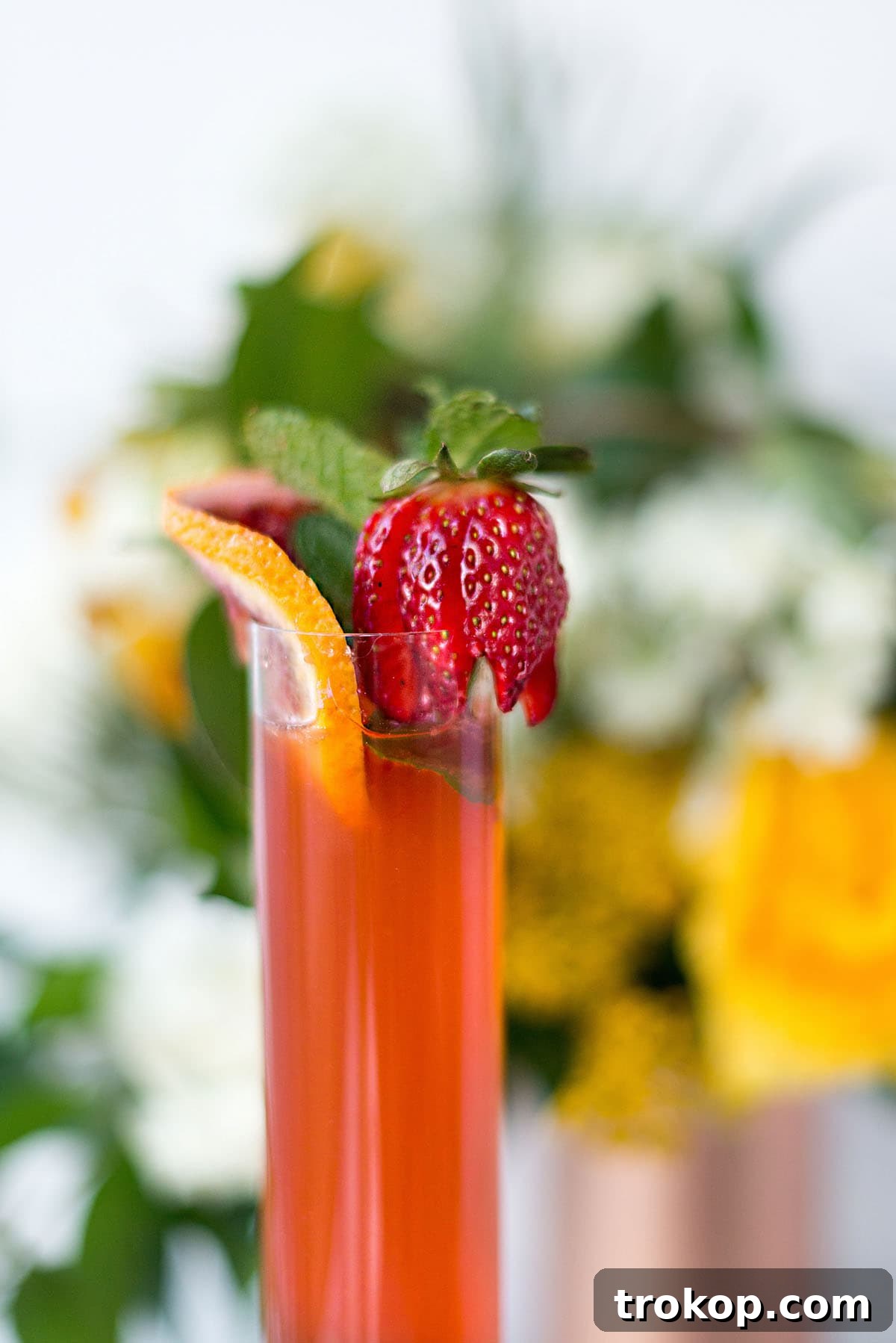 Summer Pimms Sparkler 8 Garnishing the Sparkling Pimm's Cup with fresh fruit and mint