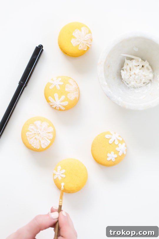Step-by-step guide showing how to paint wildflowers on macarons