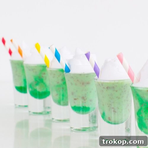 Crème de Menthe Ice Cream Shots ready for serving, garnished with whipped cream and a hint of green liqueur.