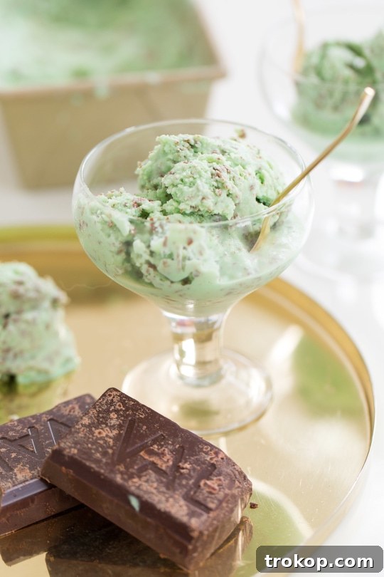 A tray of assembled Creme de Menthe Ice Cream Shots, garnished with chocolate curls, ready for serving at a party.