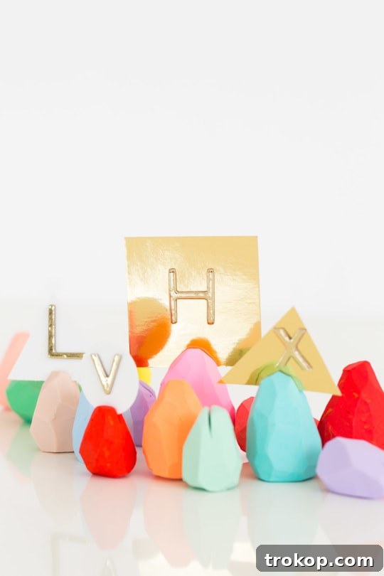 Collection of colorful DIY faceted Easter egg place card holders arranged on a table.